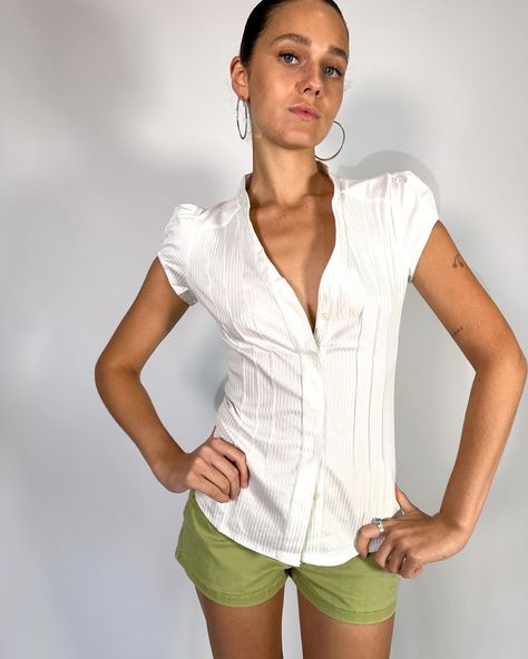 Vintage Deadstock short Cap Sleeve White shirt in amazing subtle stripe stretch fabric for a snatched fit! This is the perf corporate baddie , office siren piece ! Available in size XS, S, M & L . Model wears size S . $78 free postage australia wide . . . #whiteshirt #pinterestoutfit #vintagefashion #y2kfashion #pinterestasthetic White Fitted Shirt Women, Fitted Blouses For Women, Office Siren Shirt, White Blouse Outfit Work, Short Sleeve Shirt Outfit Women, Fitted Shirt Outfit, Baddie Office, White Shirt Women, Vintage Striped Shirt