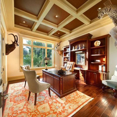 Pleasing to the eye, this home office could cater to both genders. Taxidermy and mahogany bookshelves lends a more masculine vibe, while details like the traditional rug and tufted chairs offer a bit of femininity. We especially love the coffered ceiling! Mahogany Desk Office, Mahogany Desk Office Decor, Mahogany Bookshelves, Bookshelves Desk, Mahogany Office, Masculine Home Office, Tufted Chairs, Masculine Office, Small Workspace