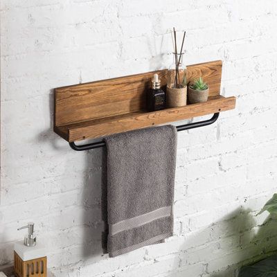 Featuring an intriguing blend of rustic and industrial style, this wall-mounted burnt wood and metal pipe towel hanging rack is a great way to add functional organization and a unique decorative accent to your bathroom or kitchen. This towel rack includes a metal bar for hanging towels, as well as a top shelf for storing supplies and accessories. Featuring a distinctive torched wood and industrial metal aesthetic, this towel bar is an excellent decorative complement to your bathroom, kitchen, or Wood Towel Holder, Hanging Bath Towels, Rustic Towel Rack, Wood Towel Rack, Hanging Towel Rack, Bathroom Hand Towel Holder, Wall Towel Racks, Bathroom Wood Shelves, Mounted Towel Rack