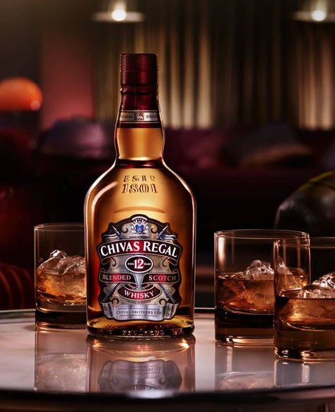 Chivas Regal has a distinctive taste that is smooth, rich, and slightly sweet, with notes of honey, vanilla, and ripe fruit. The finish is long and warm, with a gentle smokiness. Chivas Regal is packaged in a signature green glass bottle with a gold label, and a distinctive shape that has become synonymous with the brand. Chivas Regal is a popular whisky brand worldwide, and is often enjoyed neat or on the rocks, as well as in cocktails. Drinks Ads, Whisky Chivas, Strong Cocktails, Chivas Regal, Blended Whisky, Whisky Bar, Whisky Tasting, Blended Scotch Whisky, Cigars And Whiskey