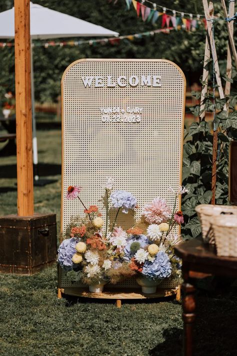 charming rattan wedding welcome sign with pastel primary color floral arrangements for a sunny outdoor ceremony Brides 2024, Bespoke Decor, Minimal Contemporary, Colourful Wedding, Wedding Backdrop Design, Wedding Brides, Organic Wedding, Future Wedding Plans, 2024 Wedding