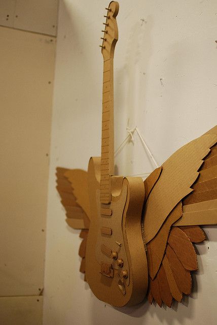 Cardboard winged-guitar by atduskgreg, via Flickr Paper Guitar, Cardboard Paper Mache, Cardboard Guitar, Cardboard Art Sculpture, Cardboard Props, Diy Cardboard Toys, Guitar Diy, Cardboard Crafts Diy, Cardboard Box Crafts