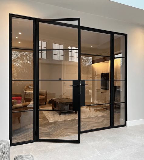 Affordable Elegance with Black Aluminium Crittall Style Doors: Elevate your home's interior and exterior with the timeless appeal of Crittall style doors. This blog post offers practical tips on how to incorporate these sleek, black aluminium doors into your space, ensuring luxury and style on a budget. Ideal for homeowners looking for a high-end look with affordability. Black Metal Office Door, Black Frame Door Exterior, Crittall Style Doors, Black Crital Doors, Large Crittal Doors, Black And Glass Doors Interior, Black Paned Glass Wall, Glass Wall Black Frame, Double Crittal Doors