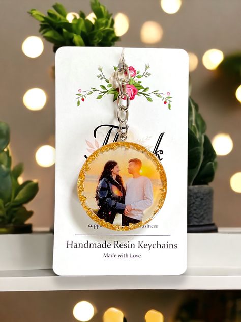 A beautiful couple photo resin keychain is a heartfelt keepsake that encapsulates the essence of love in a tangible form. The delicate resin encases a cherished photograph, capturing a moment frozen in time, radiating with the warmth and tenderness shared between two souls✨❤️ #Resinkeychain #Couplephotoresinkeychain #Giftideas #giftideasforher #amarcrafts Resin Art Photo Keychain, Resin Keychain Photo, Resin Round Keychain, Resin Couple Gift Ideas, Resin Photo Keychain Ideas, Resin Photo Keychain, Photo Resin, Resin Idea, Couple Keychains