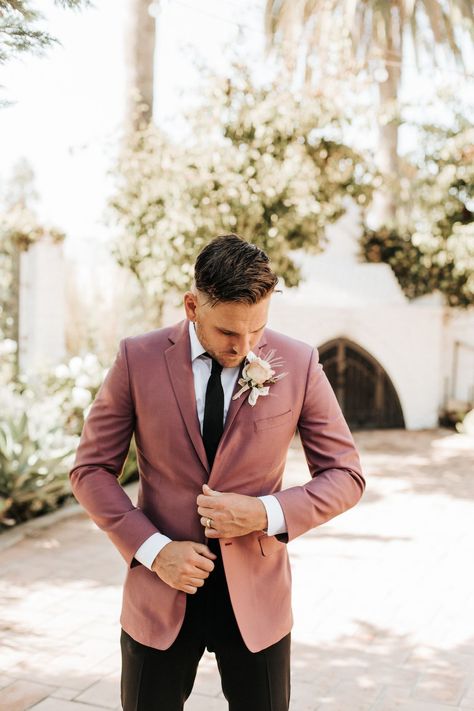 Groom wedding style with pink suit jacket - Sydney Bliss Photography | You'll Love The Boho Touches At This Modern Elopement. A Classic Black and White Wedding Color Palette is Elevated to A Contemporary Look - Belle The Magazine Pink Men Wedding Outfit, Groom Mismatched Suit, Colored Wedding Tuxedos, Trending Grooms Suits, Rose Tuxedo Wedding, Wedding Suits Men Boho Style, Groom Suit Color Schemes, Grooms In Colored Suits, Pink Mens Wedding Suit