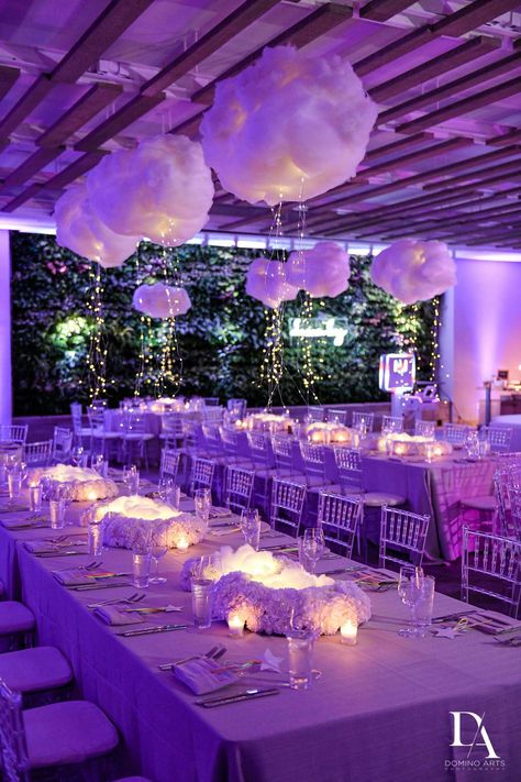 Ofir Creative executed this modern “Dream Big'' Bat Mitzvah perfectly. The celebration featured bright purple uplighting throughout the ballroom, chic lounge areas, and tables dressed in lush white florals with unique hanging cloud balloons and lights. Guests enjoyed an elaborate candy buffet before dancing the night away to live entertainment. Cloud Balloons, Purple Uplighting, Hanging Cloud, Outdoor Rehearsal Dinner, Bat Mitzvah Themes, Mitzvah Decor, Hanging Clouds, Baby Shower Venues, Birthday Venues