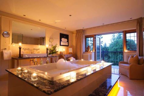 Thinking Of Putting A Hot Tub Inside Your House? Pros & Cons Of Indoor Hot Tub Installation https://homebuilding.thefuntimesguide.com/indoor-hot-tub-installations/ Bath, Candles, Tub Room, Hot Tub Room, Bath Tub, Corner Bathtub, In The Middle, Hot Tub, The Middle