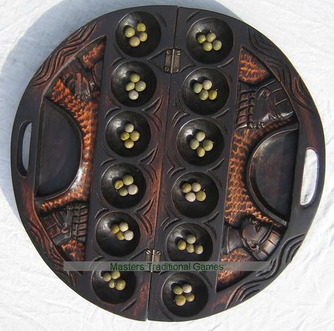 Ornate Mancala Carved Circular Oware game (Mahogany stained with bonduc seeds) Oware Game, Mancala Game Aesthetic, Mancala Game Diy, Diy Mancala Board, Clay Mancala Board, Ceramic Mancala Game, Indigenous Games, African Board Games, Ancient Games