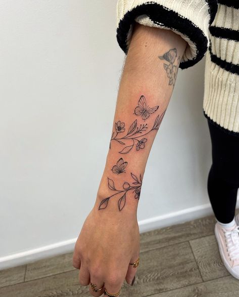 Vine Women Tattoo, Hummingbird And Ladybug Tattoo, Wrap Around Forearm Tattoo Women Butterflies, Tattoo Ideas Female Top Of Arm, Quarter Sleeve Flower Tattoos For Women, Vines On Forearm Tattoo, Small Arm Wrap Tattoo, Forearm Vine Wrap Tattoo, Floral Wrap Around Tattoo Upper Arm