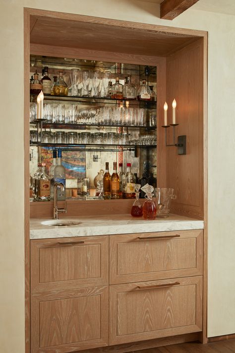 Built in bar station. Wood beam ceiling, backlit, recessed drink storage + display with built in refrigerator below. Basement Drink Ledge, Bar Cabinet Display, Pantry Converted To Bar, Built In Bar Cupboard, Built In Cocktail Bar, Recessed Coffee Bar, Built In Bar With Seating, Bar Wood Design, Recessed Bar Ideas