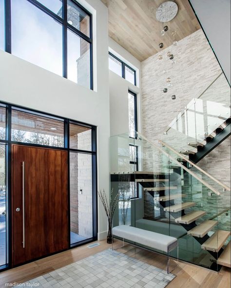 Making a statement with this front entrance • Our custom integrated residence welcomes you inside with this stunning ambience. A mahogany… Glass Stairs Design, Modern Foyer, Staircase Design Modern, Glass Stairs, Modern Entrance, Stairs Design Modern, Stairway Design, Modern Entryway, Modern Style House Plans