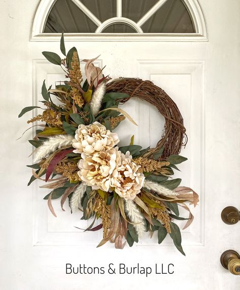 This fall wreath has cream peonies, seeded stems, and lots of flowing eucalyptus greenery. This wreath measures 22” wide and at 25” in length. Order processing time is 2 weeks. Fall Wreath With Feathers, Fall Wedding Wreaths For Door, Wreaths For Windows Inside, Fall Wedding Wreath, Wreath With Letter, Unique Fall Decor, Western Wreath, Year Round Wreaths, Tiny Bouquet