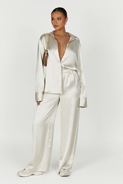 Match point. MARCIELA is a straight-leg pant tailored in a soft, woven satin fabrication and detailed with an encased elastic waistband and impeccable fit. The versatile, slip on design and minimal stretch provide a flattering fit, while the elastic waistband ensures a secure hold. What's more, they're in a lovely ivory hue that will pair with almost everything. Wear with our Nori Satin Shirt, your favourite sneakers and add a cap for an instant lift on your outfit. FEATURES: Encased elastic at Instant Lifts, Match Point, Straight Leg Pant, Satin Pants, Halter Neck Top, Satin Shirt, Design Minimal, On Design, Long A Line