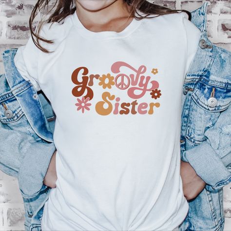 Get groovy with our Youth Groovy Sister T-Shirt! This tee captures the retro style of the '60s and '70s, making it perfect for your sibling groovy birthday party. Crafted with comfort and durability in mind, it's an ideal choice for all-day fun. Let your child's style and embrace the groovy vibes with this cool and timeless t-shirt! Groovy Shirt, Sister Tshirts, Sister Shirts, Matching Shirts, Crew Neck Tee, Family Shirts, Kids Tops, Jersey Fabric, Retro Fashion