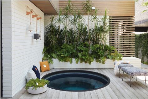 A sunken spa nestles into the corner of the courtyard, with a metal ring encircling it and concealing the cut ends of the ipe deck. The design team suggested a round tub early on in the project, both to contrast the rest of the courtyard’s mostly square design and to suggest the feeling of a Japanese soaking tub.   Glass mosaic tiles cover the spa, creating a dark and subtle space. “[It adds a] quietness and mystique,” Jones says. “It’s not bright and blue.” Sunken Hot Tub, Contemporary Deck, Rustic Pergola, Hot Tub Deck, Japanese Soaking Tubs, Hot Tub Backyard, Hot Tub Garden, Wooden Deck, Jacuzzi Outdoor