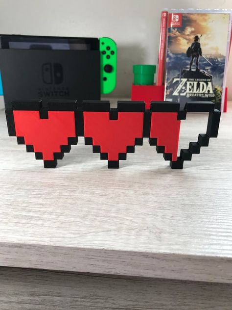 This is an awesome 3D printed Zelda Hearts video game sign. Dimensions are 183mm x 61mm x 10mm!It is printed in high quality PLA plastic and looks great. This is printed in the colors seen, not painted!Other colors available upon requestPlease see pictures and ask any questions you may have. Free shipping, they are pre printed and ready to ship!Please see my shop for many other logo signs :)All rights to respective owners, this is fan art.Any accessories shown are NOT included.Due to the nature Nature, Video Game Home Decor, Game Room Paint Colors, Zelda Room Decor, Diy Gamer Decor, Zelda Bedroom, Zelda Room, Video Game Bedroom, Hearts Video