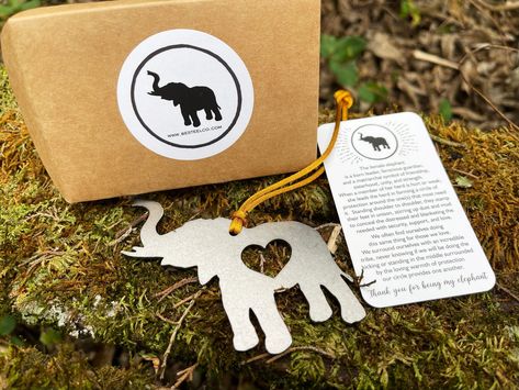 "This raw steel elephant ornament comes gift wrapped in a heavy duty kraft paper envelope with a card explaining the story behind the ornament. The card reads: The female elephant is a born leader, ferocious guardian, and a matriarchal symbol of friendship, sisterhood, unity, and strength. When a member of her herd is hurt or weak, she leads the herd in forming a circle of protection around the one(s) that most need it. Standing shoulder to shoulder, they stamp their feet in unison, stirring up Circle Of Protection, Female Elephant, Born Leader, Elephant Ornament, Friendship Symbols, Heirloom Gifts, Memorial Ornaments, Meaningful Messages, Raw Steel