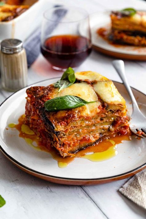 Eggplant Parmesan or Melanzane Alla Parmigiana is a tasty Italian vegetarian meal. Fried eggplants baked with tomato sauce and three types of cheese. Eggplant Parmigiana Italian, Vegetarian Eggplant Parmesan, Authentic Italian Eggplant Parmesan, Eggplant Parmesan Italian Style, Eggplant Melanzane Recipe, Authentic Eggplant Parmesan, Parmegiana Eggplant, Italian Food Vegetarian, Melanzane Parmigiana Recipes