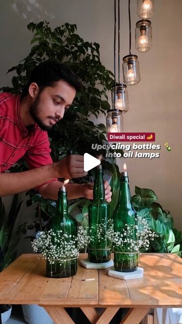 Siddham Jain | Plants & Decor on Instagram: "Diwali Special 🪔 इस दिवाली let's Upcycle Glass Bottles 🍾 into Oil Lamps. Let's Brighten the corners with sustainability. 🔅 Starting with cleaning the bottles 🍾 and removing the stickers. Here's the #Hack dip/pour the warm water on the sticker. This will soften it and easily peel it. If after Removing the sticker the marks are left then use Turpentine oil to get off. . 🔅Add any oil, here adding mustard oil for good flame. Add a thick cotton rope dipped in oil and hold it with a rope holder. A part of the rope outer side of the holder. . 🔅 Specifically if any festive season add any flowers of you choice and place them on side tables, center tables. Last but not the least infinite the rope and enjoy the vibe. . Share this who is waiting to cr Diwali Bottle Decoration, Upcycle Glass Bottles, Oil Lamp Decor, Turpentine Oil, Memorial Decor, Center Tables, Diwali Special, Side Lamps, Diwali Decoration