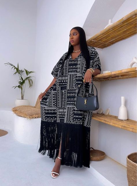 Introducing the Mihlali Dress Black, a stunning piece showcasing a gorgeous exotic African print adorned with fringe detail. The perfect choice for any special occasion, this dress is certain to make a statement of elegance and sophistication, making you stand out from the crowd. Model is 5ft 11in and she is wearing one size fits all. See our size guide pages/size-guide]  Delivery & Returns pages/delivery-returns] Women Classy Summer Outfits, Vacation Dress Outfits, Abaya Designs Latest Simple, Boubou Gown Styles, Kaftan Dress Modern, Simple Abaya Designs, Bubu Gown, Boubou Styles For Women, Bubu Gown Styles