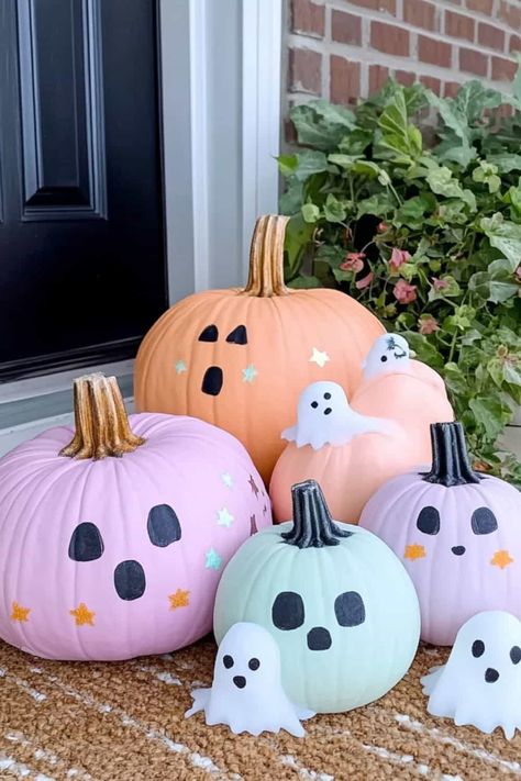 Four pastel pumpkins with ghost candels sitting on a doorstop. Pumpkin Painting Ideas Minimalist, How To Paint A Pumpkin For Halloween, Easy Halloween Carving Pumpkin Ideas, Easy Painting Ideas On Pumpkins, Tiny Painted Pumpkins Ideas, Decorate Small Pumpkins Ideas, Pumpkin Painting Ideas For White Pumpkins, Ideas For Painted Pumpkins, Painted Pumpkin Inspiration