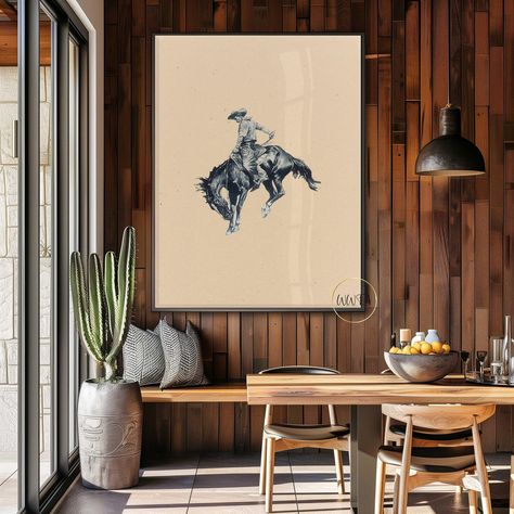 Vintage Cowboy Art Print: This captivating artwork depicts a rugged cowboy atop a bucking bronco, capturing the raw energy and daring spirit of the Old West in a timeless, vintage style. 𝐅𝐞𝐚𝐭𝐮𝐫𝐞𝐬: *Premium Quality: Printed on high-grade paper to ensure long-lasting durability and a professional finish. *Variety of Sizes: Available in multiple dimensions to fit any space, from small cozy corners to large statement walls. *Detailed Artworks: Each poster showcases intricate details of weste Goth Western Decor, Southwest Entryway, Western Modern Decor, Southwestern Office, Cowboy Living Room, Vintage Cowboy Art, Western Room Decor, Rugged Cowboy, Southwest Modern