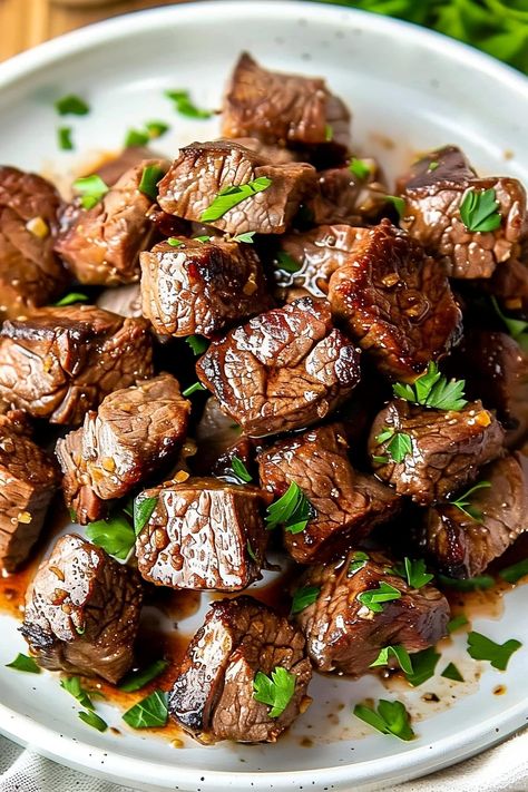 These garlic butter steak bites are quick, easy, and fabulous! Tender sirloin is cooked to perfection then drizzled with freshly made garlic butter. Mediterranean Steak Bites, Steak Bites Charcuterie, Beef Stew Meat Steak Bites, Steak Stovetop Recipes, Skillet Beef Tips, Beef New York Strip Steak, Ribeye Strip Recipes, Top Sirloin Strip Steak Recipes, Tender New York Strip Steak