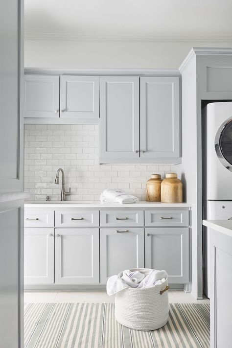 With a little effort, the laundry room can be just as stylish and organized as the rest of the house. From painted cabinetry and detailed tilework to unique hardware and storage baskets, these 30 beautiful laundry rooms offer plenty of inspired ideas for transforming your laundry room into a standout space you'll want to show off to guests.  #laundryroom #laundryroomideas #laundryroomorganization #modernlaundryroom Stacked Laundry Room, White Laundry Rooms, Laundry Room Ideas Small Space, Dream Laundry Room, Casa Loft, White Laundry, Laundry Room Layouts, Laundry Room Renovation, Modern Laundry Rooms