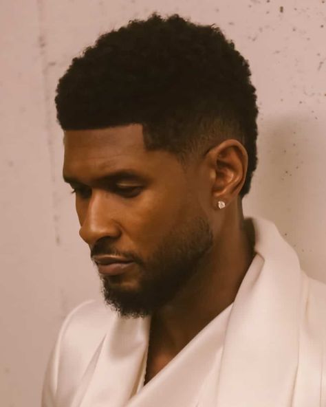 Usher short afro with low taper fade haircut. This hairstyle first appeared in the article: Low Taper Fade Haircut: What It Is & The Best Styles For 2022, on MensFlair.com Frohawk Fade, Low Fade Haircut Men's, Crew Cut Haircut, Fade Haircut Curly Hair, Low Taper Fade Haircut, Black Boys Haircuts, Low Taper Fade, Afro Fade, Low Taper