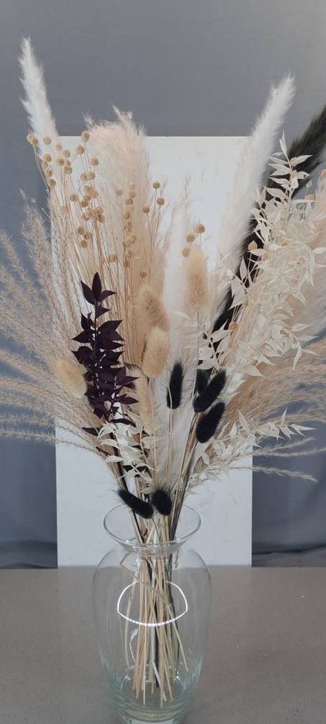 This beautiful white and cream pampass grass, ruscus and black bunnytail bouquet is dried and preserved ready for your home. The bouquet is 52-60cm tall and includes a variation of  -Cream, black and white fluffy pampas grass stems -Black and white ruscus stems  - Natural and black bunnytails. Care instructions included. Please note that the variation of pampas grass might look different due to lighting Gift wrapping option available Black Pampas, Pampas Grass Home Decor, White Ruscus, Grass Bouquet, Cream Decor, Pampas Grass Bouquet, Grass Decor, Pampas Grass Decor, Apartment Decor Inspiration