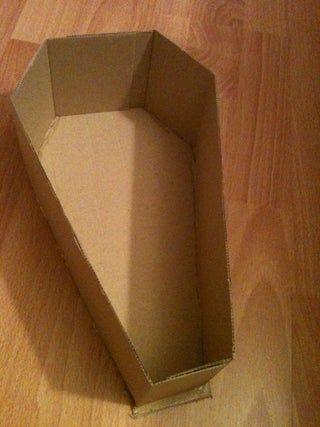 Easy Halloween Coffin : 8 Steps - Instructables Diy Coffin Halloween Cardboard, How To Make A Coffin Out Of Cardboard, Cardboard Coffin Diy, Halloween Coffin Decoration, Cardboard Coffin, Rip 20s, Egyptian Halloween, Coffin Decor, Coffin Shelf