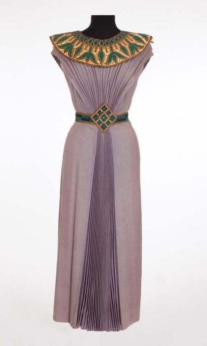 Dorothy  Kirsten “Louise Heggar” Egyptian dress from The Great Caruso. (MGM,  1951) Light purple wool Egyptian style dress with gold, blue and green  collar and belt.  Handwritten label “7663 1514 Dorothy Kirsten.”  Worn  by Dorothy Kirsten as “Louise Heggar” during the final trio �“O terra,  addio” scene in the opera, Aida in The Great Caruso. Egyptian Style Dress, Ancient Egyptian Dress, Egyptian Inspired Fashion, Egypt Clothing, Ancient Egyptian Fashion, Egyptian Dress, Ancient Egypt Fashion, Egyptian Clothing, Egyptian Fashion