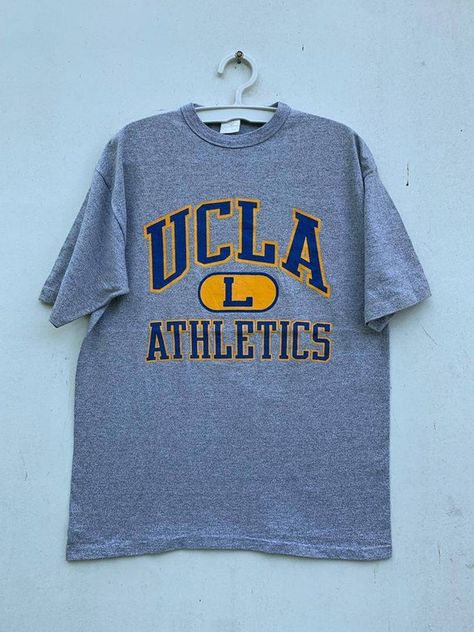 Check out this item in my Etsy shop https://www.etsy.com/listing/1260840360/vintage-80s-ucla-athletics-university-of Ucla T Shirt, University Tees Design, College Graphic Tee, University Shirt Design, College Tshirt Designs, Vintage Hoodies Aesthetic, Ucla Shirt, Vintage College Shirts, University Merch