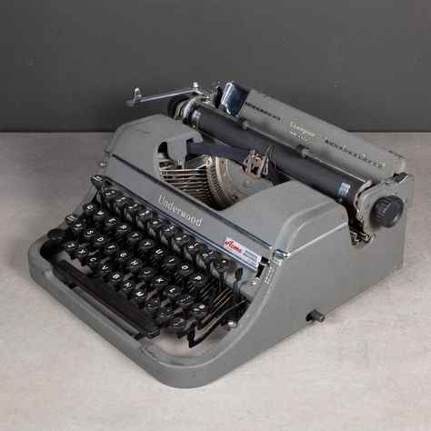 ABOUT  A vintage portable Underwood Champion Four bank typewriter in grey finish and original case. This typewriter is very clean and in good working order. It has smooth typing and the carriage advances and functions very well. The ribbon is good. The case is original with a Bakelite handle engraved "Underwood". Serial #G1659396.      CREATOR Underwood Typewriter Co.     DATE OF MANUFACTURE c.1946.     MATERIALS AND TECHNIQUES Steel, Metal, Bakelite, Glass.     CONDITION Good. Wear consistent with age and use. Minor wear on the body of the typewriter and the case. Missing the key caps for the right shift, tab, and 1/2 keys. Missing feet.      DIMENSIONS H 6 in. W 12.5 in. D 12 in., Case: H 7 in. W 13 in. D 12.5 in.   HISTORY  Unknown. Olivetti Typewriter, Underwood Typewriter, Working Typewriter, Study Desk Decor, Van Life Diy, Portable Typewriter, Key Caps, Vintage Typewriters, Study Desk