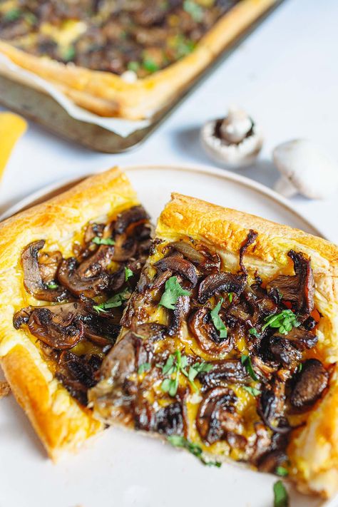 mushroom tart on a creamy plate and on a baking sheet, white mushrooms