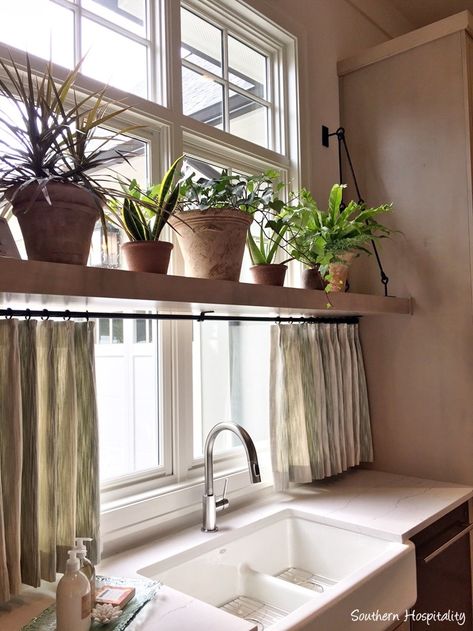 Kitchen Sink Off Center Of Window, Window Ledge Ideas Kitchen, Behind The Kitchen Sink Decor, Kitchen Window Shelf For Plants, Above Kitchen Sink No Window Ideas, Kitchen Sink And Window Ideas, Cute Kitchen Window Ideas, Shelves In Front Of Windows Kitchen, Over Window Plant Shelf