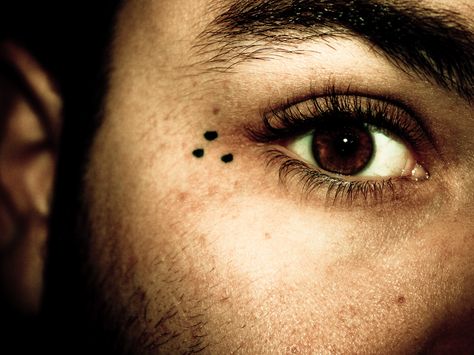 The three dots tattoo is a very common prison tattoo that symbolizes 'mi vida loca' or 'my crazy life.' It doesn't symbolize any particular gang, but rather the gang lifestyle. It's typically found on the hands or around the eyes. Three Dots Tattoo Meaning, Prison Tattoo Meanings, Dot Tattoo Meaning, 3 Dot Tattoo, Dotted Tattoo, Under Eye Tattoo, Tattoo On Face, Triangle Tattoo Meaning, Eye Tattoo Meaning