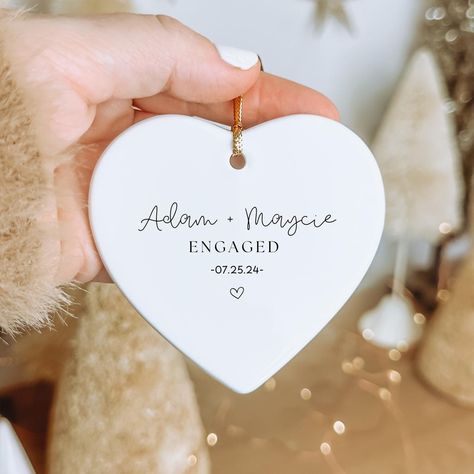 Our personalized couples engagement or newly married ornament will light up the holiday season. Personalize this as a gift for yourself, or give it to somebody special in your life. Our ornaments are made of ceramic and have a glossy finish. They measure 2.75" in diameter and include a gold string for hanging. Our ornaments are ready to gift and will arrive in a gift box! If you have any questions about ordering, please send us a message! ♥️NO CANCELLATIONS AFTER 12 HOURS OF ORDER PLACEMENT. PRO Engagement Gifts Newly Engaged, Engaged Ornament, Engagement Ornament, Christmas Engagement, Couples Ornaments, Married Ornament, Engagement Ornaments, Lafayette La, Engagement Announcement