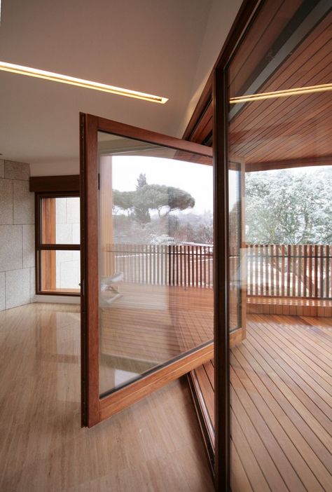 Large wood framed windows rotates open onto wooden front balcony. Studio Dwelling / cmA Arquitectos. Inside Of A House, Fasad Design, Pivot Door, Garage Studio, Sliding Glass Doors, White Cottage, Window Door, Design Del Prodotto, Decoration Inspiration