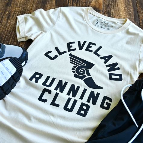 Join the Cleveland Running Club for a fun and quirky workout experience! Connect with fellow runners and explore the city while staying active. Unleash your inner athlete with this heather cream running club shirt. Designed and printed locally in Cleveland on a super soft unisex crewneck heather black tee shirt (52% cotton / 48% poly) Polyester retains shape and elasticity; Cotton lends both comfort and durability. Fits like a well-loved favorite, featuring a crew neck, short sleeves and designe 5k Shirt Design, Marathon T-shirt, Rawdawg Run Club, Team T Shirt Designs, Gym Merch, Graphics Board, Run Club, Boxing Club, Black Tee Shirt