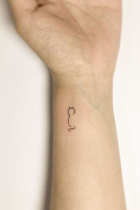 Small Minimalist Tattoo Design For Wrist #wristtattoo #cattattoo Tattoos For Women 2024, Cat Wrist Tattoos For Women, 31 Small Tattoos With Big Meanings, Tiny Cat Tattoos For Women, Cat Tattoo Wrist, Cat Tattoo Leg, Mimalistic Tattoo, Hamster Tattoo Minimalist, Minimalist Tattoo Ideas Women