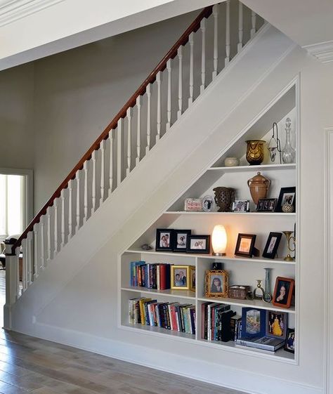 an open storage under built into the staircase is a cool bookcase that doesn't require any floor space Under Steps Storage, Living Room Under Stairs, Shelves Under Stairs, Cabinet Under Stairs, Stairs Pantry, Staircase Bookshelf, Stair Bookshelf, Under Stairs Storage Ideas, Stairs Storage Ideas