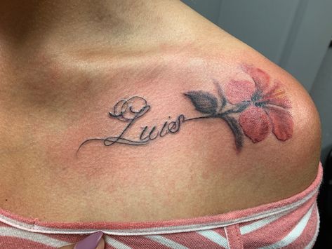 Elegant script tattoo with flower near collarbone with the name “Luis”. Name Collarbone Tattoo, Name Tattoo On Collar Bone For Women, Elegant Name Tattoos, Luis Name Tattoo, Collar Bone Tattoo Name, Collar Bone Name Tattoo, Collarbone Name Tattoo, Under Collar Bone Tattoos, Luis Tattoo