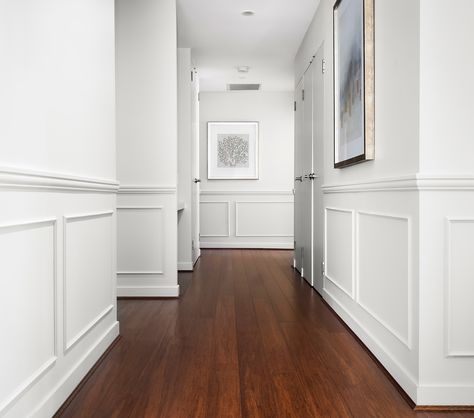 A hallway is an experience – a quiet journey that connects spaces, creating a flow throughout your home. It’s not just a transitional area; it’s a path that sets the tone, directing you where to go and how to feel as you move through it. Now, let’s talk about wainscoting. It’s not just about adding a decorative feature; it’s about bringing that hallway to life. With wainscoting, the walls aren’t just there to hold up the roof – they become part of the journey, Adding depth, character, And... Wainscoting Small Hallway, Hallway Moulding Wainscoting, Wall Moulding Entry Way, Wainscoting Hallway Ideas, White Wainscoting Cream Walls, Hallway Molding Ideas, Ornate Wainscoting, How Tall Should Wainscoting Be, Wainscoting Dimensions