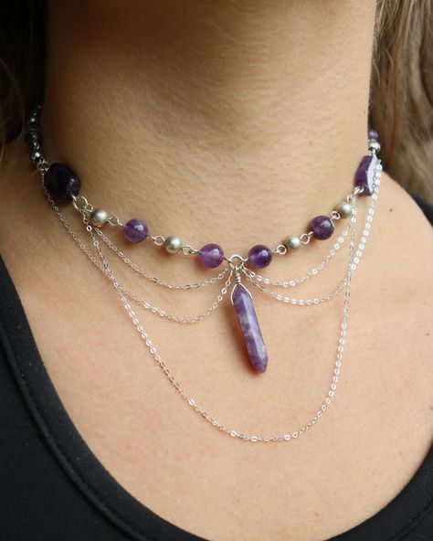 amethyst x lepidolite sterling choker This baby has more chain than most my other chokers, just experimenting with their placement and what not ⛓️ she features amethyst beads in various forms, and a lepidolite crystal dangling in the center, all made with sterling wire! You can find her listed on my website with a few other chokers uploaded recently!🫶🏼 • • • • • • #crystaljewelry #wirewrapping #wirewrap #wirejewelry #wirewrappedjewelry #silverjewelry #silverwirejewelry #handmadechoker #ear... Handmade Amethyst Choker Jewelry, Handmade Purple Beaded Choker Necklace, Purple Adjustable Handmade Choker, Purple Amethyst Wire Wrapped Necklaces, Purple Amethyst Wire Wrapped Crystal Necklace, Silver Wire Jewelry, Lepidolite Crystals, Handmade Chokers, Dope Jewelry