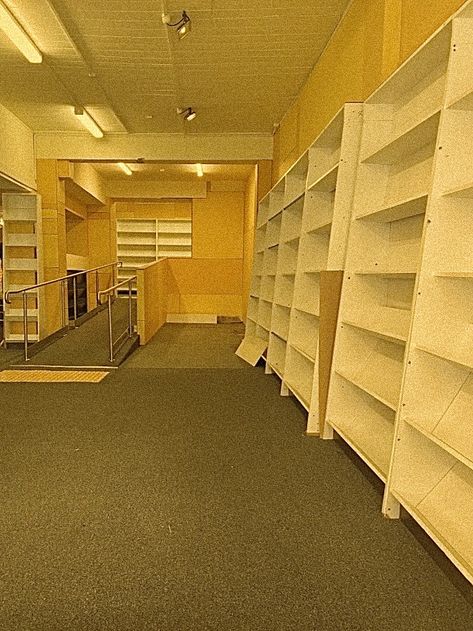 yellow-lit empty backrooms / library Space Pictures