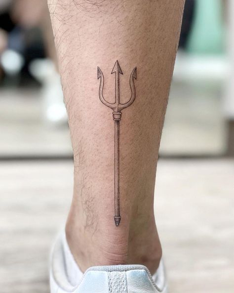 Small trident tattooed on the left calf by @soychapa Mens Trident Tattoo, Trident Leg Tattoo, Calf Tattoo Men Minimalist, Feminine Trident Tattoo, Minimalist Trident Tattoo, Mens Calf Tattoos Ideas Simple, Trident Forearm Tattoo, Greek Trident Tattoo, Poseidon Tattoo Minimalist