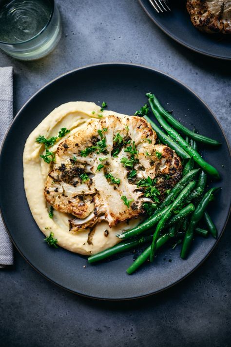 These flavorful oven roasted cauliflower steaks make for a delicious vegan/vegetarian main dish for Thanksgiving, Christmas or any other entertaining occasion! Vegetarian Main Dish, Cauliflower Steaks Recipes, Cauliflower Steak, Roasted Cauliflower Steaks, Oven Roasted Cauliflower, Crowded Kitchen, Drink Inspiration, Xmas Dinner, Cauliflower Steaks