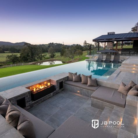 Which do you like best? Sunken fire pit? Raised fire lantern? One way to ensure year-round enjoyment of your swimming pool is to incorporate a fire or flame feature in the design.🔥 #OutdoorLifestyle #GoldCoastHomes #FireFeature