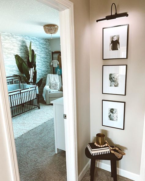 Small Space Photo Wall, Light Above Photo Wall, How To Decorate Small Hallway Wall, Hallway Wall Decor Narrow, Stair Landing Photo Wall, Upstairs End Of Hallway Ideas, Pictures At End Of Hallway, Wall Sconces Next To Picture, Frames On Wall With Lights